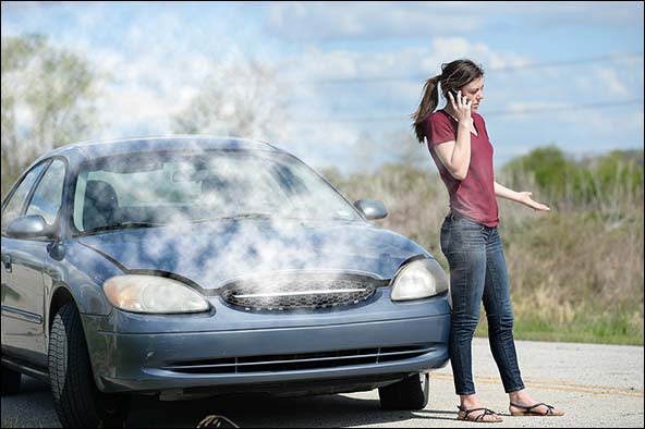 Engine overheating and girl on smart phone